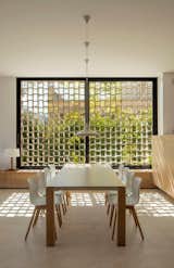Dining Room, Ceiling Lighting, Limestone Floor, Chair, Pendant Lighting, and Table  Photo 5 of 14 in M24 House by OLARQ Osvaldo Luppi Architects