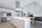 Kitchen, Concrete, Quartzite, Wall Oven, Range Hood, Cooktops, Refrigerator, Ceiling, and White  Kitchen Refrigerator Quartzite Cooktops White Ceiling Photos from Favorites