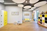 Kids, Chair, Playroom, Boy, Shelves, Storage, Bookcase, Pre-Teen, Light Hardwood, and Rockers therapy room/ playroom with round acoustic ceiling panels  Kids Rockers Light Hardwood Photos from House E