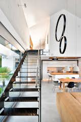 The lasecut steel staircase connects the open living space to the upper floor.