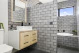 Bath Room, Concrete Floor, Wood Counter, Subway Tile Wall, Ceramic Tile Wall, Ceiling Lighting, Open Shower, Two Piece Toilet, Pedestal Sink, and Drop In Tub  Photo 14 of 19 in Dune 1 by Inverloch 3996
