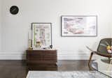 The Frame TV was hung on the wall with the low back accent chair to keep simple materiality in the living room. 