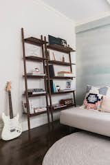 The guest bedroom is brightened up with light sky-blue wallpapers coupled with cute details.