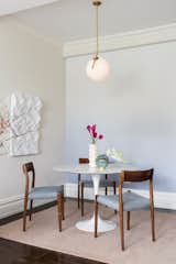 Dining area open to the living room has settled on the rug in blush shade.