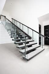 A stunning, metal staircase is the most prominent of the two staircases in the home. 