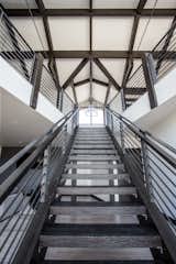 The lines in the beams and stairway give the most amazing visual appeal in this modern home.