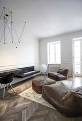 Living Room, Recliner, Chair, Pendant Lighting, Ottomans, Desk, Ribbon Fireplace, and Medium Hardwood Floor  Photos from Interior AM