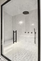 Minimalist black fixtures adorn the shower.
