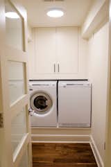 The laundry room features a washer and dryer by Swedish manufacturer Asko