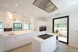 Kitchen, White Cabinet, Ceramic Tile Floor, Recessed Lighting, Cooktops, Wall Oven, Marble Counter, Refrigerator, Range, Drop In Sink, and Dishwasher Chef's kitchen  Photo 3 of 4 in Le Mas de la Cordeliere, Sun-Splashed Saint-Tropez Villa Asks €4.9m by London International Realty
