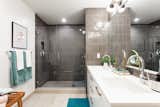 Master Bathroom with his & hers vanities, frameless glass showers, and GROHE faucets