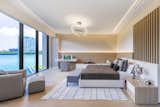 Sleek master bedroom with natural, wood accents and stunning water views  