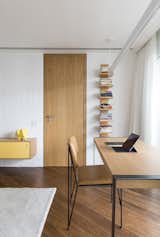 Bedroom, Shelves, Medium Hardwood Floor, Pendant Lighting, Chair, and Bookcase  Photo 18 of 27 in CKO Apartment by David Ito Arquitetura