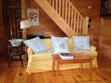 Living Room, Coffee Tables, Bench, Light Hardwood Floor, Sofa, Bookcase, and End Tables One of the two cabins   Photo 15 of 40 in Maine Lake House & Cabins (Family Camp Compound) by Christina Sidoti