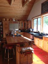 Kitchen, Refrigerator, Range, Wood Cabinet, Stone Slab Backsplashe, Light Hardwood Floor, and Concrete Backsplashe Kitchen   Photo 7 of 40 in Maine Lake House & Cabins (Family Camp Compound) by Christina Sidoti