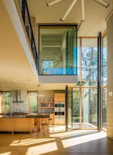 Kitchen, Glass Tile Backsplashe, Ceiling Lighting, Engineered Quartz Counter, Microwave, Light Hardwood Floor, Wood Cabinet, Undermount Sink, Accent Lighting, Wall Oven, and Range Hood  Photo 2 of 9 in White Stone by Randall Kipp