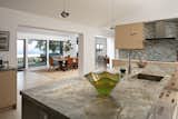 Looking over the kitchen island to the dining room and ocean view