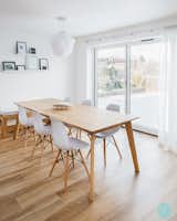 View of the dining area featuring a bench at the end. 