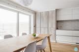 View of the dining table and kitchen tall units which house a small coffee bar with a toaster and a microwave