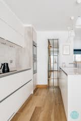 View of the bespoke shelving separating the kitchen from the hallway; the shelving is both practical and creates interest in both hallway and kitchen.