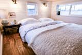 Bedroom, Night Stands, Bed, Dark Hardwood Floor, and Wall Lighting Loft with lots of headroom.  Photo 17 of 24 in Solar Tiny for Family of 5. by Tru Form Tiny