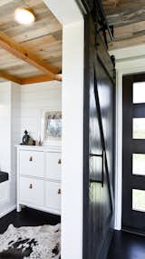 Office, Craft Room Room Type, Study Room Type, Storage, and Dark Hardwood Floor Office with Barn Door. Tru Form Tiny  Photo 2 of 28 in Full Solar Tiny Home & Open Layout by Tru Form Tiny