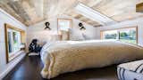 Bedroom, Wall Lighting, Dark Hardwood Floor, and Bed Loft with Skylight. Tru Form Tiny  Photo 8 of 28 in Full Solar Tiny Home & Open Layout by Tru Form Tiny