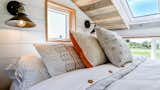 Bedroom, Wall Lighting, and Bed Loft with several windows. Tru Form Tiny  Photo 11 of 28 in Full Solar Tiny Home & Open Layout by Tru Form Tiny