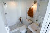 Bath Room, Marble Floor, Wall Lighting, Vessel Sink, Subway Tile Wall, Two Piece Toilet, and Full Shower Tiled Bathroom in Urban Park Studio by Tru Form Tiny  Photo 15 of 15 in 15 Tiny Bathroom Ideas For a Beautiful and Functional Space from Tiny Home & ADU - Open Living