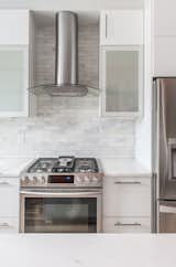 The white cabinets and traditional subway tile in marble make for a timeless combination in this kitchen in Washington, D.C.