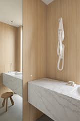 The vanity floats off the back wall to eliminate the need for a backslash allowing wood walls to surround the powder room. 