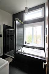Bath Room, Alcove Tub, Porcelain Tile Wall, Ceiling Lighting, Enclosed Shower, and One Piece Toilet A bath with a view   Search “bathtubs--alcove” from The Parent-Coté house