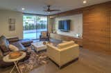 TV Area Features Walnut Cabinetry and Hickory Wood Floors