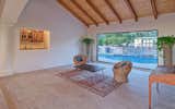 Formal or Casual Living Area Overlooks Inviting Pool with Water Feature