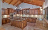 Chef's Kitchen With Alder Wood Cabinetry And Soaring Ceilings