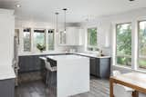 Kitchen, Dark Hardwood Floor, Ceiling Lighting, White Cabinet, and Colorful Cabinet A multi-step finish with a Hardwax Oil offers richness and depth with slight hints of chocolate and lavender on our Reclaimed Ash flooring.   Photo 3 of 3 in Scandinavian Farmhouse by Pioneer Millworks