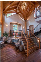 Staircase, Wood Railing, and Wood Tread From the floor to the stair treads and landing, American Gothic Reclaimed Walnut flooring makes a statement in this family home.  Photo 2 of 5 in Lakeside Retreat by Pioneer Millworks