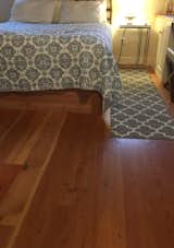 The ADU bedroom include reclaimed Knotty'n'Naily Douglas fir flooring.