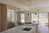 Kitchen, Track Lighting, Refrigerator, Light Hardwood Floor, Marble Counter, Wood Cabinet, and Stone Counter  Photo 5 of 8 in Foal Home and Studio