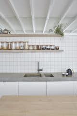 Bespoke joinery, tiled finishes, concrete tops and high-level mirrors to the kitchen