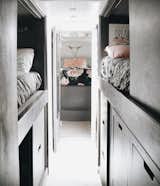 Bedroom, Vinyl Floor, Ceiling Lighting, Bed, Wall Lighting, Storage, Dresser, and Wardrobe Looking towards the back of the bus you can see our bunk house, bathroom, and master bedroom  Photo 5 of 9 in Blue Steel, Our Self Coverted School Bus Tiny Home by Ashley