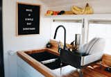 Kitchen, Drop In Sink, Wood Counter, Wood Backsplashe, Vinyl Floor, White Cabinet, Ceiling Lighting, and Refrigerator This is the kitchen sink which is dropped into our custom built butcher block counter top.  Photo 7 of 9 in Blue Steel, Our Self Coverted School Bus Tiny Home by Ashley