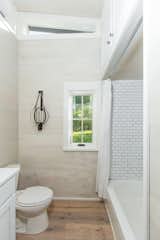 The bathroom includes a tub with tile surround.
