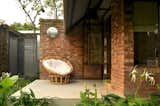 Outdoor, Metal Fences, Wall, Trees, Hanging Lighting, Small Patio, Porch, Deck, Grass, Horizontal Fences, Wall, Back Yard, and Shrubs  Photo 9 of 12 in LHTE Guest Bungalow Extension by SILT