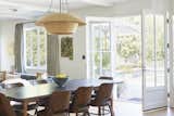 Nickey Kehoe Interiors, Farrow & Ball Paint. French doors open to a manicured patio and outdoor dining setting.