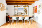 Dining Room, Medium Hardwood Floor, Pendant Lighting, Table, Shelves, and Chair Dusty also built the table and custom industrial bookshelf in the dining area.  Photos from Too Cool: This Boho Surf Shack Has a Half-Pipe in the Backyard