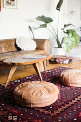 Living Room, Ottomans, Medium Hardwood Floor, Sofa, Rug Floor, and Coffee Tables There's also a global aesthetic to Julia's design choices.  Photo 2 of 36 in Furniture by Spencer Bull from Too Cool: This Boho Surf Shack Has a Half-Pipe in the Backyard