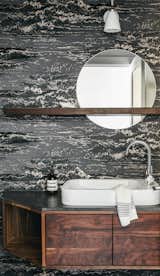 Bath Room, Vessel Sink, Wall Lighting, and Granite Counter The powder room features a dramatic wallpaper by Osborne & Little. It is a nod to the seaside home's themes of surf and water. The custom mirror shelf and floating vanity are made by Kaimade Woodworking with locally sourced Claro walnut.  Photo 12 of 23 in Balboa Residence by Landed Interiors & Homes