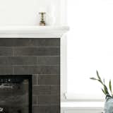 The existing fireplace surround tile matched nicely with the client's sofas and was balanced with a refinished white mantle and window bench seats.   Photo 4 of 26 in Memorial Dr Condo by Sarah Joy