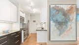  Kitchen with limestone and mica walls, black marble countertops and artwork by Paul Seftel